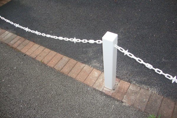 White Fence Post With White Chain and Diamond Driveway White Fence Post With White Chain and Diamond Driveway