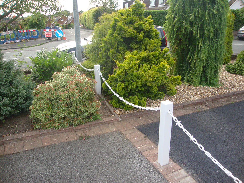 White Fence Post With White Chains and Diamonds